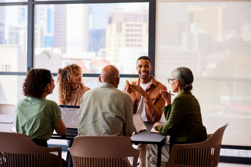 Diverse group of professionals in a business meeting at a conference table.