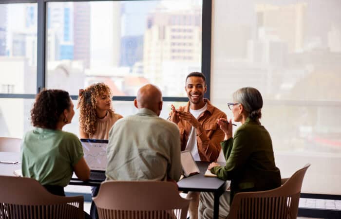 Diverse group of professionals in a business meeting at a conference table.