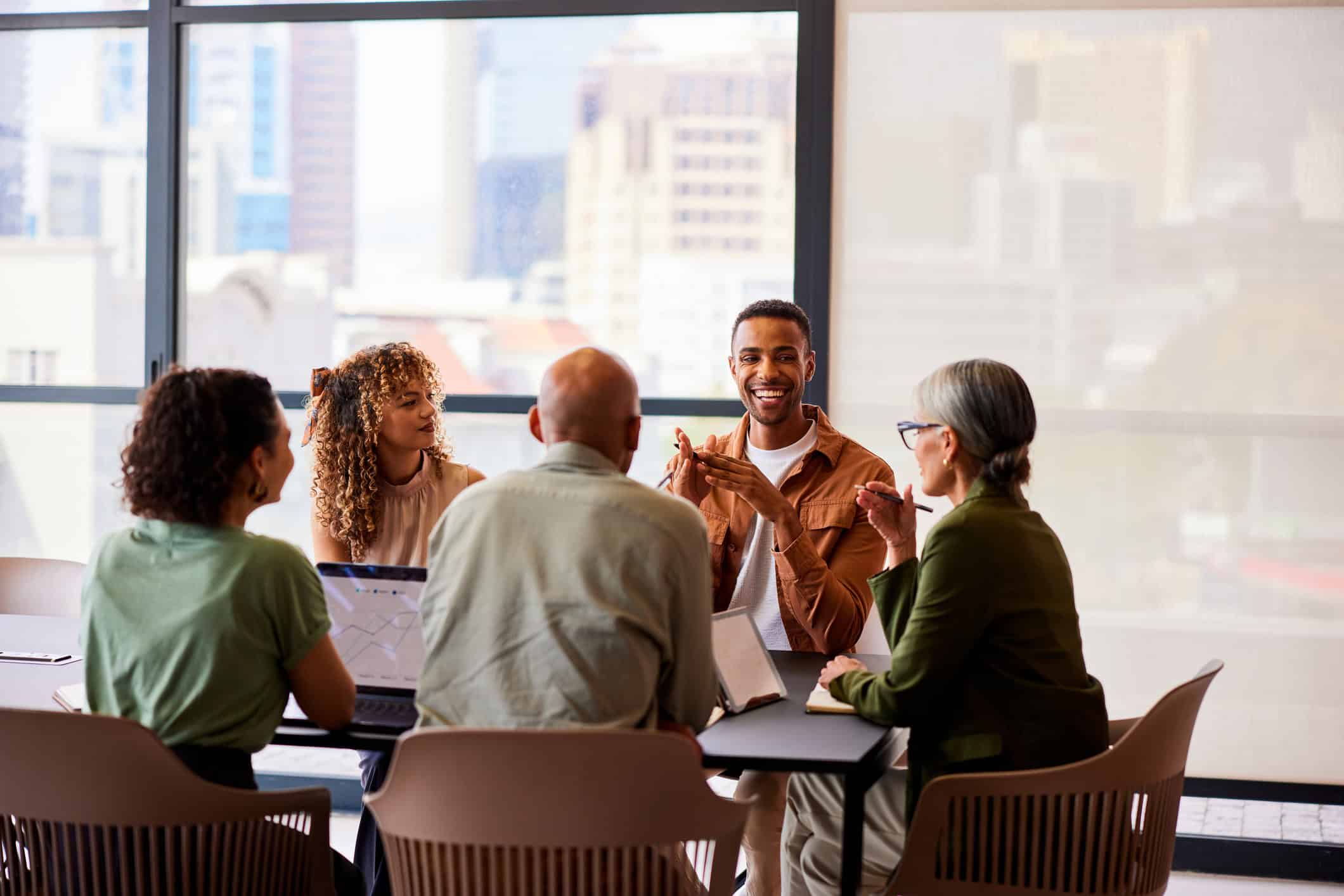 Diverse group of professionals in a business meeting at a conference table.